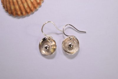 EA55. Dished circular silver earrings with silver ball