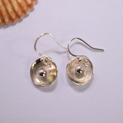 EA55. Dished circular silver earrings with silver ball