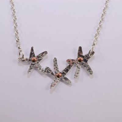 NP24. Three joined flowers with copper rivet centre