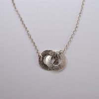 NP27. Entwined hammered silver washers