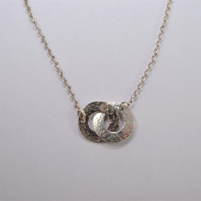 NP27. Entwined hammered silver washers