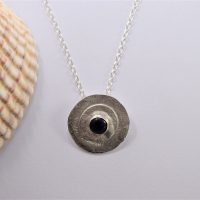 NP41. Silver reticulated layered circles with black Onyx stone