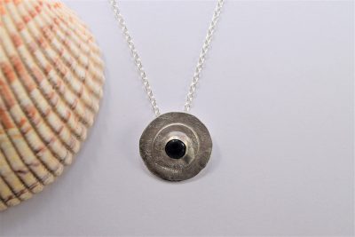 NP41. Silver reticulated layered circles with black Onyx stone