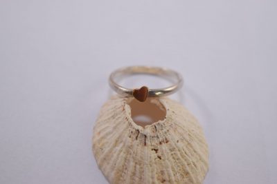R18. silver ring with tiny gold heart