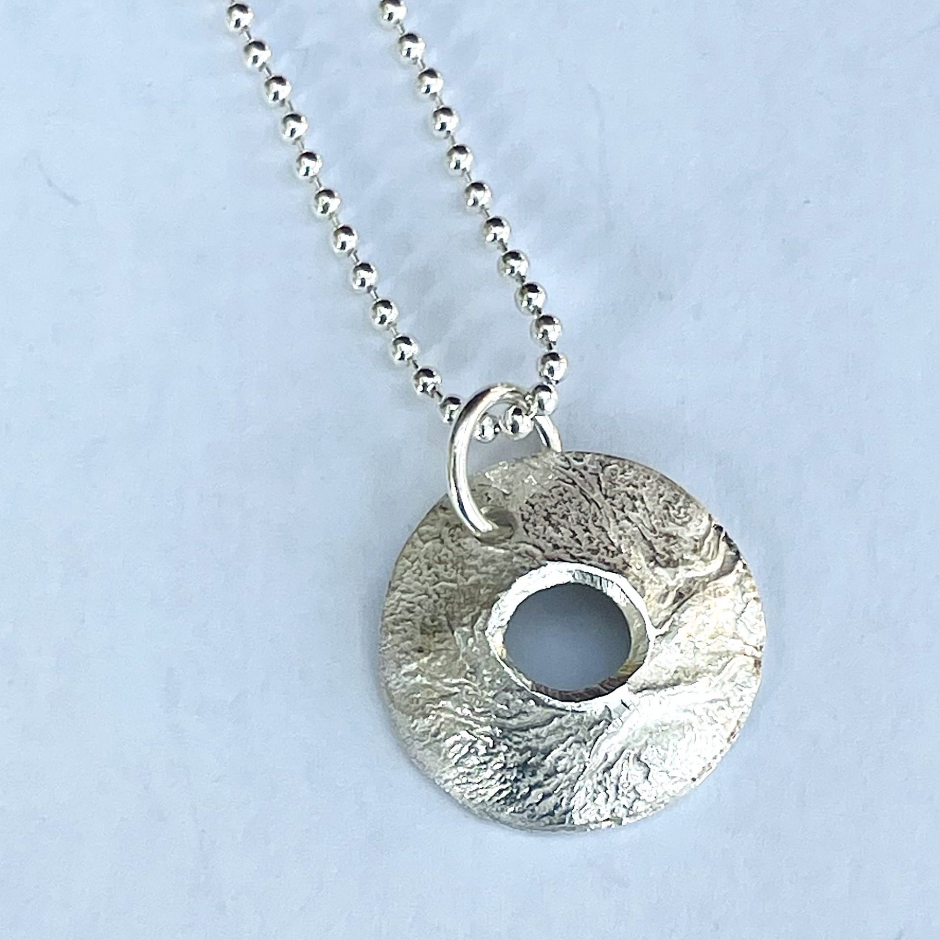 NP05. Reticulated round and domed pendant with cut out detail