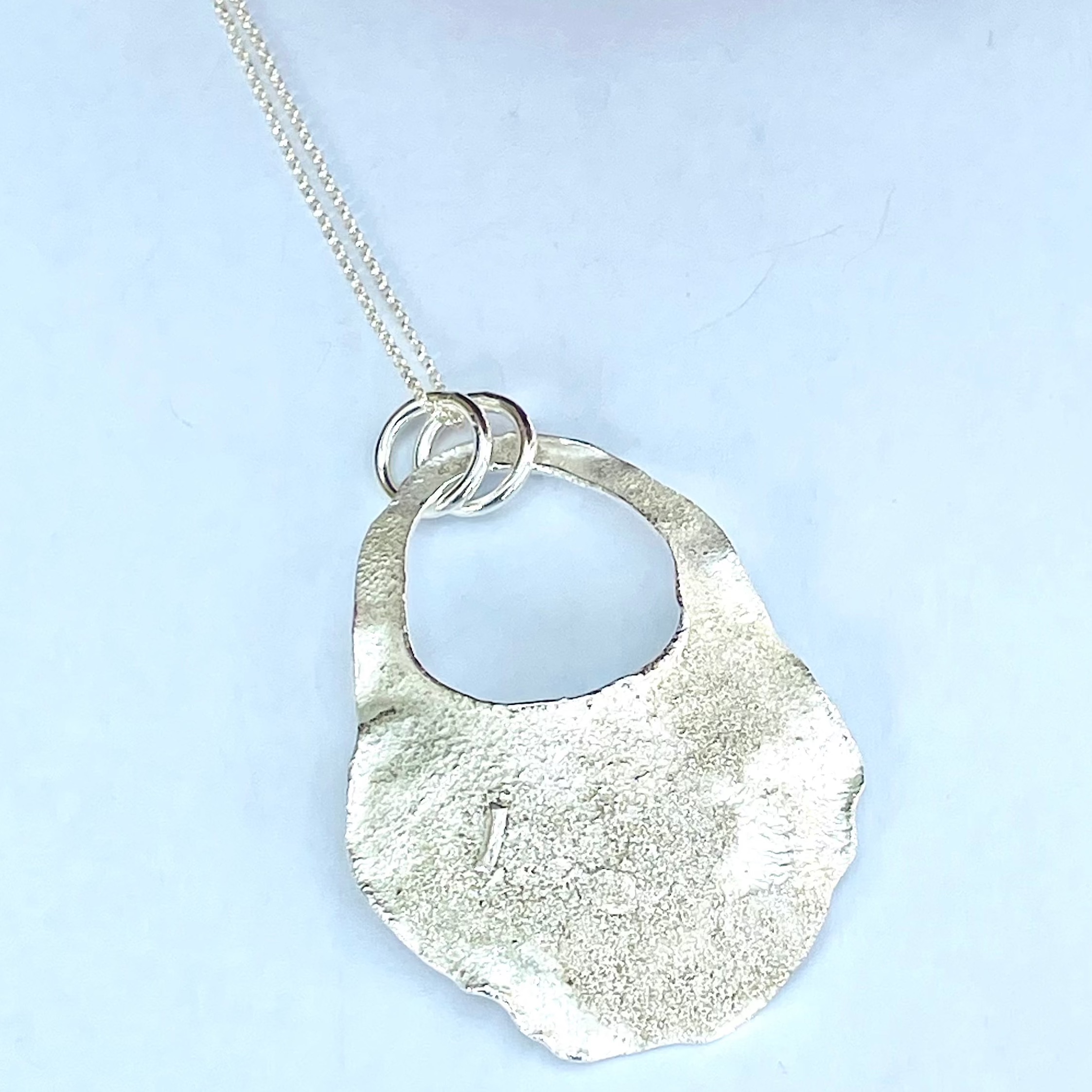 NP04. Reticulated abstract oval pendant with cut out detail