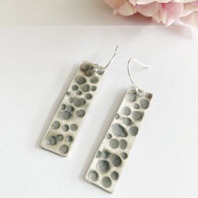 EA82. Oblong pitted earrings with oxidation